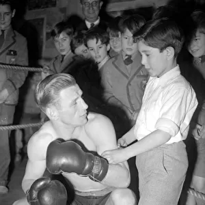 This young man is learning how to fight from a professional boxer. 1949