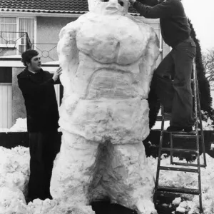 Two young men build a giant snowman, Wales, 22nd February 1978 Two young men build a giant snowman, Wales, 22nd February 1978