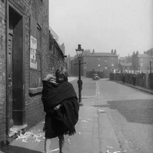 Young mother carries her child in a shawl, Liverpool. 3rd April 1939 Young mother carries her child in a shawl, Liverpool. 3rd April 1939
