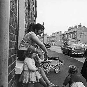 Young mother seen here with her children in the back streets of Belfast circa 1966