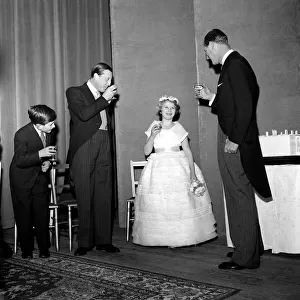A young Prince Charles January 1960 joins in a toast for his sister, Princess Anne