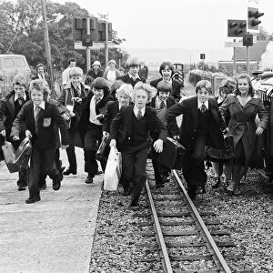 Young schoolchildren make their way to Southlands Primary School on the Romney