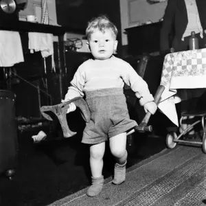 Young toddler boy holding heavy tools December 1952 C6391 Young toddler boy holding heavy tools December 1952 C6391