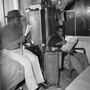 Young West Indian men in Brixton looking through the small ads in the local newspapers Young West Indian men in Brixton looking through the small ads in the local newspapers