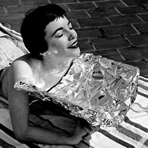 A young woman catching some rays whilst on holidays Sunbathing
