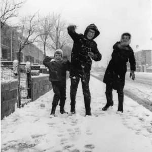 Three youngsters at Llanrumney, Cardiff throw snowballs at the cameraman during Three youngsters at Llanrumney, Cardiff throw snowballs at the cameraman during