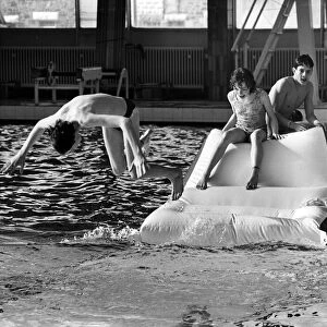 Youngsters tackle the inflatable assault course at Stanley Baths. 8th March 1986