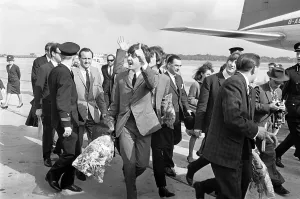10 July 1964 Paul McCartneywaves to fans as The Beatles arrive at Liverpool airport