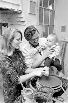 11 month old Roy Crosland has his footprint cast by making a imprint on the wet clay