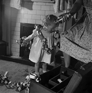 Toddlers Prints: 15 month-old Janice Cook with Christmas chains playing in the living room November