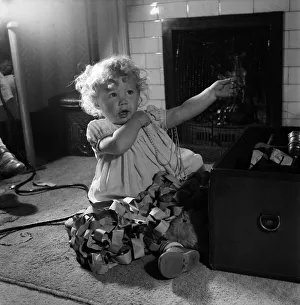 Toddlers Prints: 15 month-old Janice Cook with Christmas chains playing in the living room November