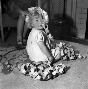 15 month-old Janice Cook with Christmas chains playing in the living room November