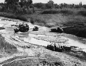 Italy Prints: A 17-Pounder anti-tank gun of the 46th Division crosses the ford of River Foglia