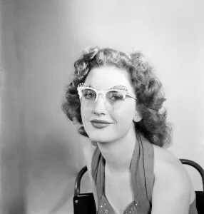 00021 Prints: 19 Yrs old actress Shirley Lorimer displaying the spectacles. May 1953 D2541-002