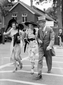 1950s Fashion Prints: 1950 Clothing Ascot Fashion Crossing the road holding onto their hats