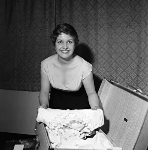 Luggage Prints: 21-year-old actress Anne Reid at home in Kensington packing her bags before leaving for