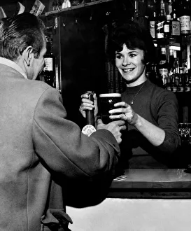 00041 Prints: 21 year old barmaid Joyce McKnight serving a customer at the Black Bull Pub in Doncaster