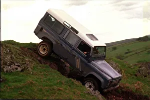 00143 Prints: 4X4 OFF ROAD INSTRUCTION FOR ROAD RECORD LAND ROVER DEFENDER GOING OVER RIDGE AT THE TOP