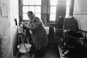 71 year old Edna Clarke does her washing in the communal wash house at Great Eastern