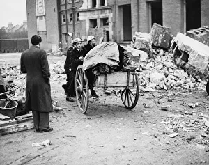 01463 Prints: A. R. P. workers taking away childrens belongings from a bombed school in Sandhurst