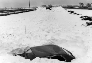 Blizzard Prints: Abandoned car lies in the path of the snow clearing machines working between Llantwit