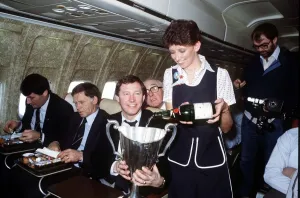 Flight Attendant Prints: Aberdeen manager Alex Ferguson receives champagne for an air hostess inthe European Cup