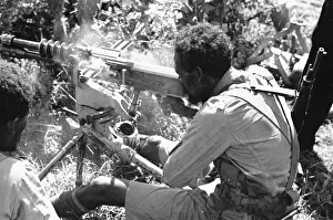 Abyssinian War September 1935 Abyssinian machine gunner firing an old Hotchkiss