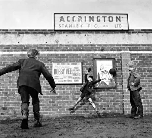 Accrington Stanley. No more football inside the ground so three youngsters play outside
