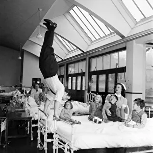 00023 Prints: Acrobat Fred Edwards performing at a childrens hospital. May 1953 D2247-001