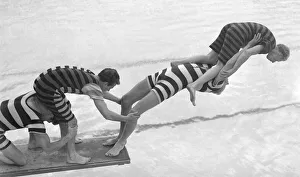 Acrobats from the Leon Marco Water Show clown about on a diving board Entertainment