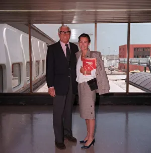 Actor Cary Grant arriving at London Airport with unidentifed woman June 1986