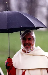Actor Christopher Lee well protected from the weather during filming of Ivanhoe for
