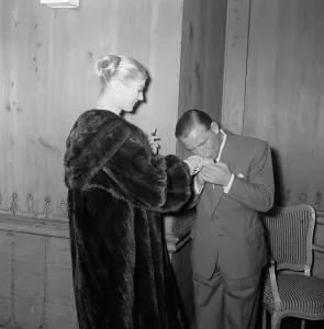 Chivalry Prints: Actor and comedian Norman Wisdom kisses the hand of actress Anita Ekberg at the savoy