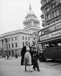 Couples Prints: Actor David Niven with French actress Genevieve Page walking through London during a