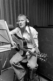 Actor Dennis Waterman, seen here in the recording studio with his guitar. December 1975