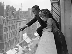 00098 Prints: Actor Douglas Fairbanks seen here with his wife throwing roses from the balcony of