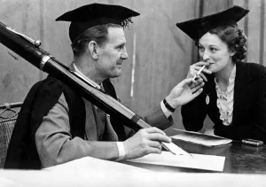 00169 Prints: Actor Will Hay seen here with an outsize pen, does the vey best to break school rule