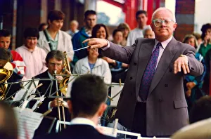 Baton Prints: Actor Ken Morley hamming it up with the Eveready Brass Band when he opened by new MFI