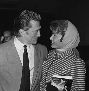 Scarves And Shawls Prints: Actor Kirk Douglas at London Airport with his wife August 1958