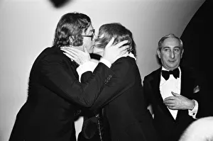 Actor Michael Caine gives a kiss to American actress Shirley MacLaine as he greets her