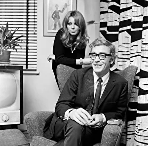 Actor Michael Caine pictured with French actress Miss Elizabeth Ercy in the flat of