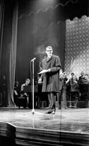 00140 Prints: Actor Peter O Toole at Stars Shine for Jack Hylton holding a cigarette on stage
