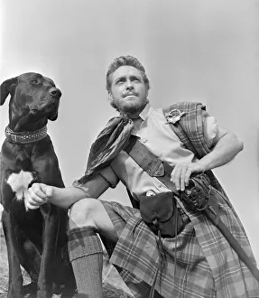 Kilts Prints: Actor Richard Todd with a black labrador in his role as Rob Roy in the film Rob Roy