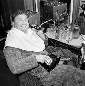 Actor and singer Harry Secombe seen here ordering and then eating a meal order from