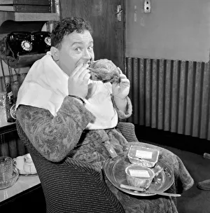 Actor and singer Harry Secombe seen here ordering and then eating a meal order from