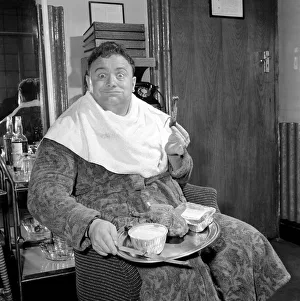 Actor and singer Harry Secombe seen here ordering and then eating a meal order from
