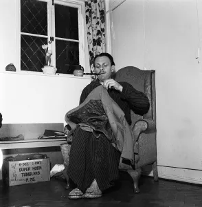 Actor Terry Thomas sitting at home sewing his coat February 1957
