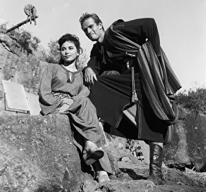 1958 Prints: Actors Haya Harareet and Charlton Heston between takes during the making of the film Ben