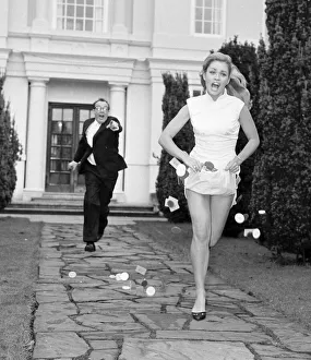 Actress Alexandra Bastedo seen here being chased by Eric Morecombe whilst filming a