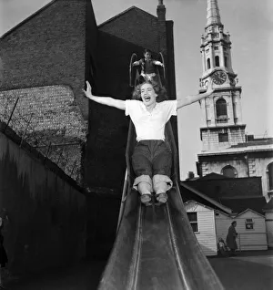 Actress Audrey Freeman -stretches out her arms as she takes a go on a slide